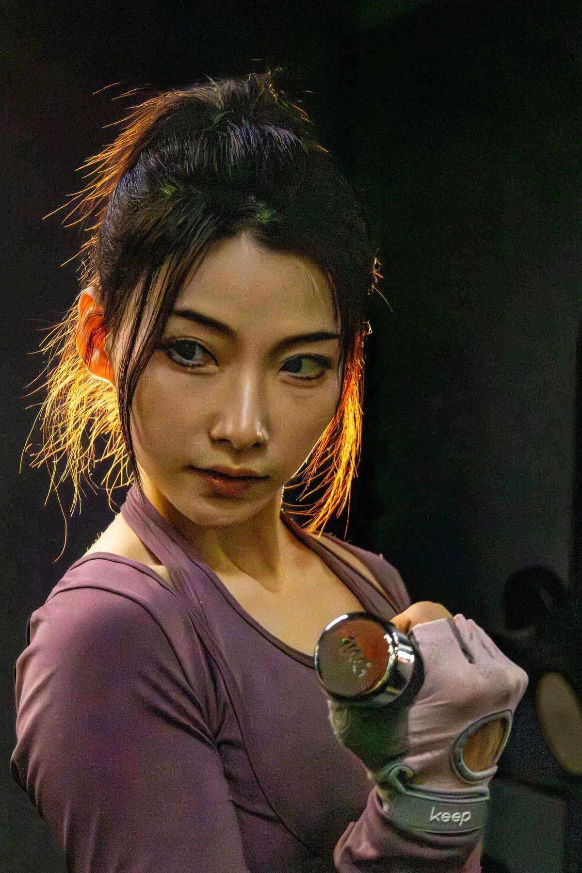 ダンベルを持ち上げるアジア人女性(イメージ写真)